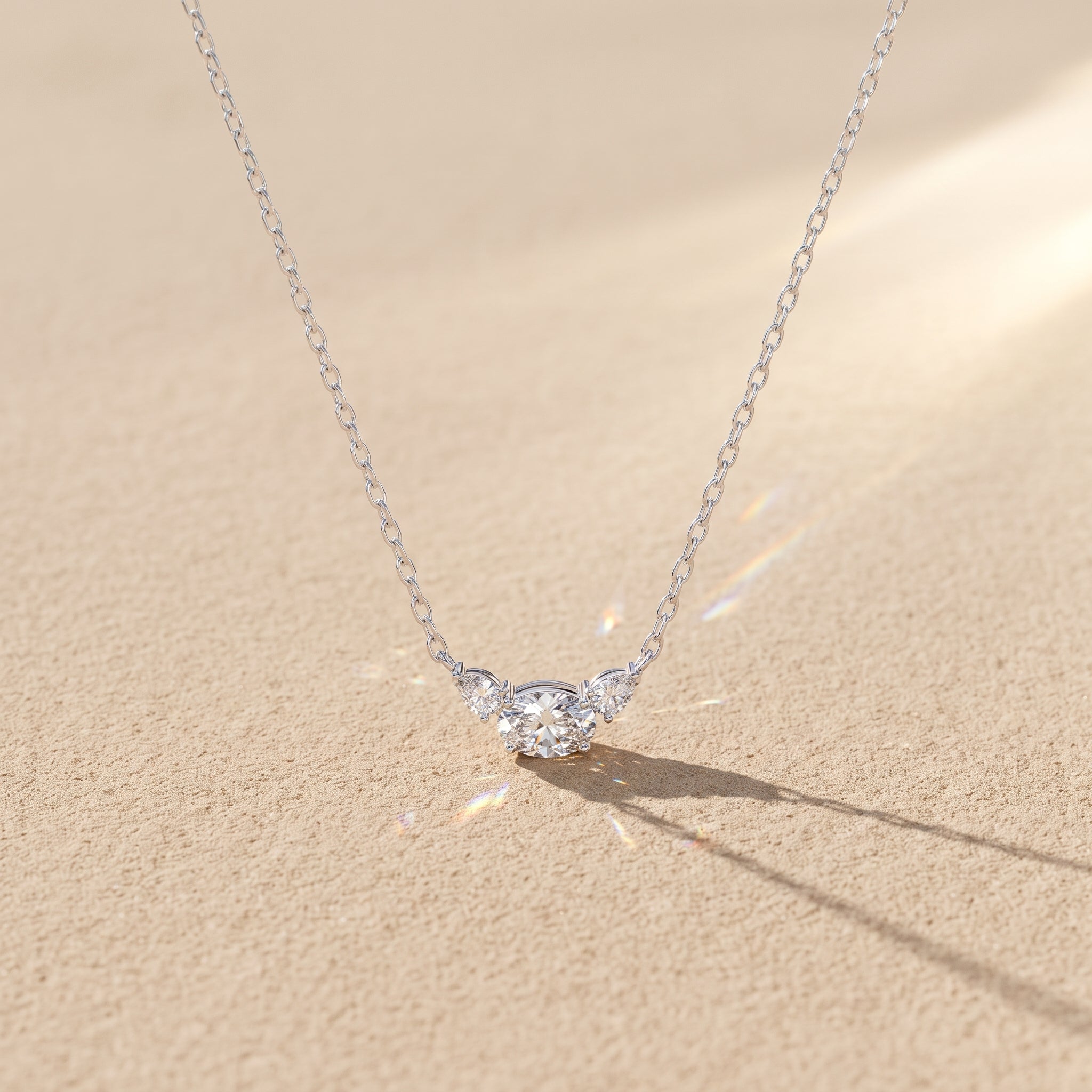 White Metal Oval Moissanite Three Stone Pendant Necklace