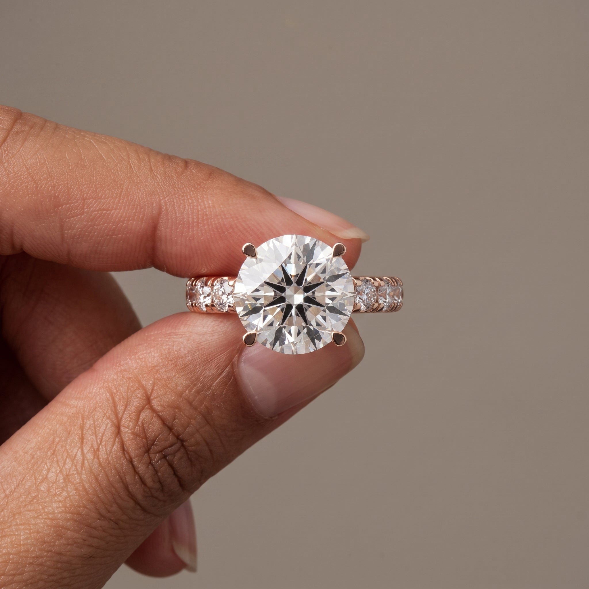 Rose Gold Round Cut Moissanite Engagement Ring with Side Stones